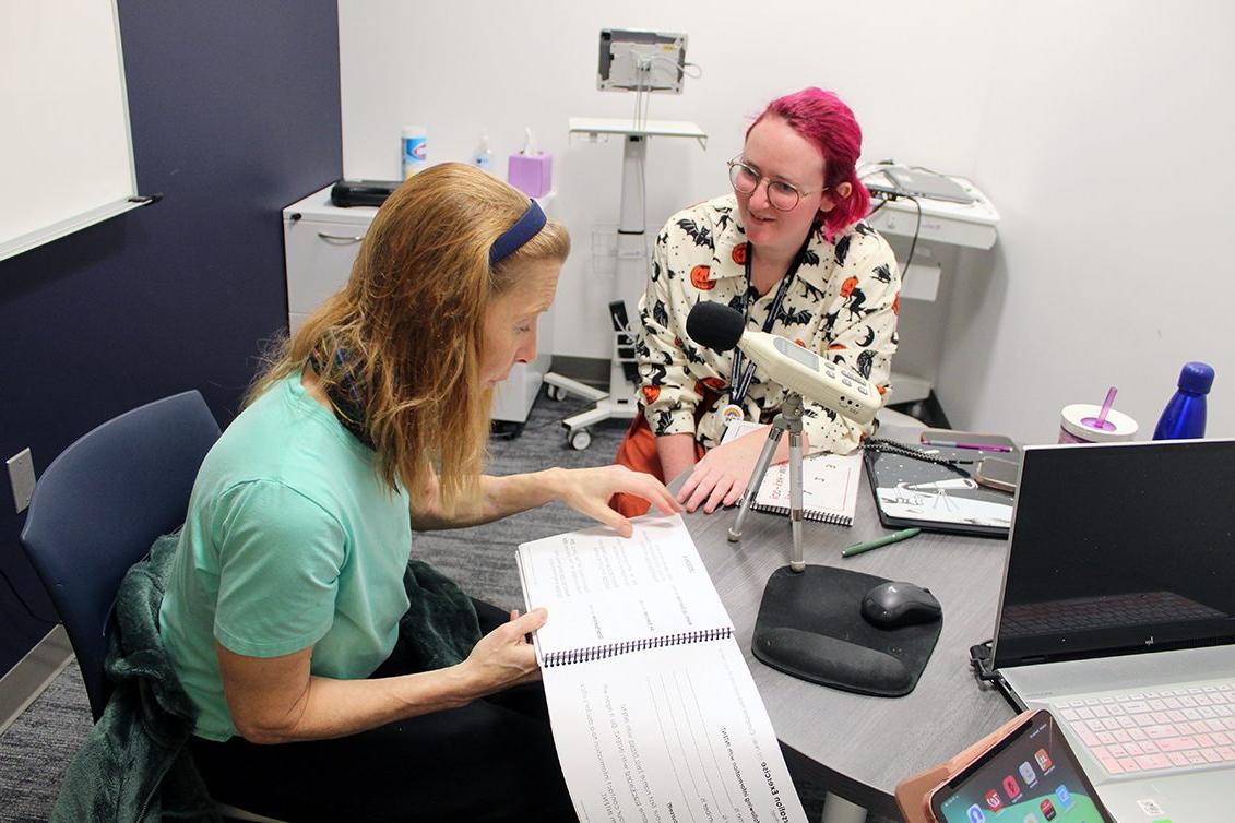 Graduate clinician (middle) and client (right) working on Parkinson Voice Therapy